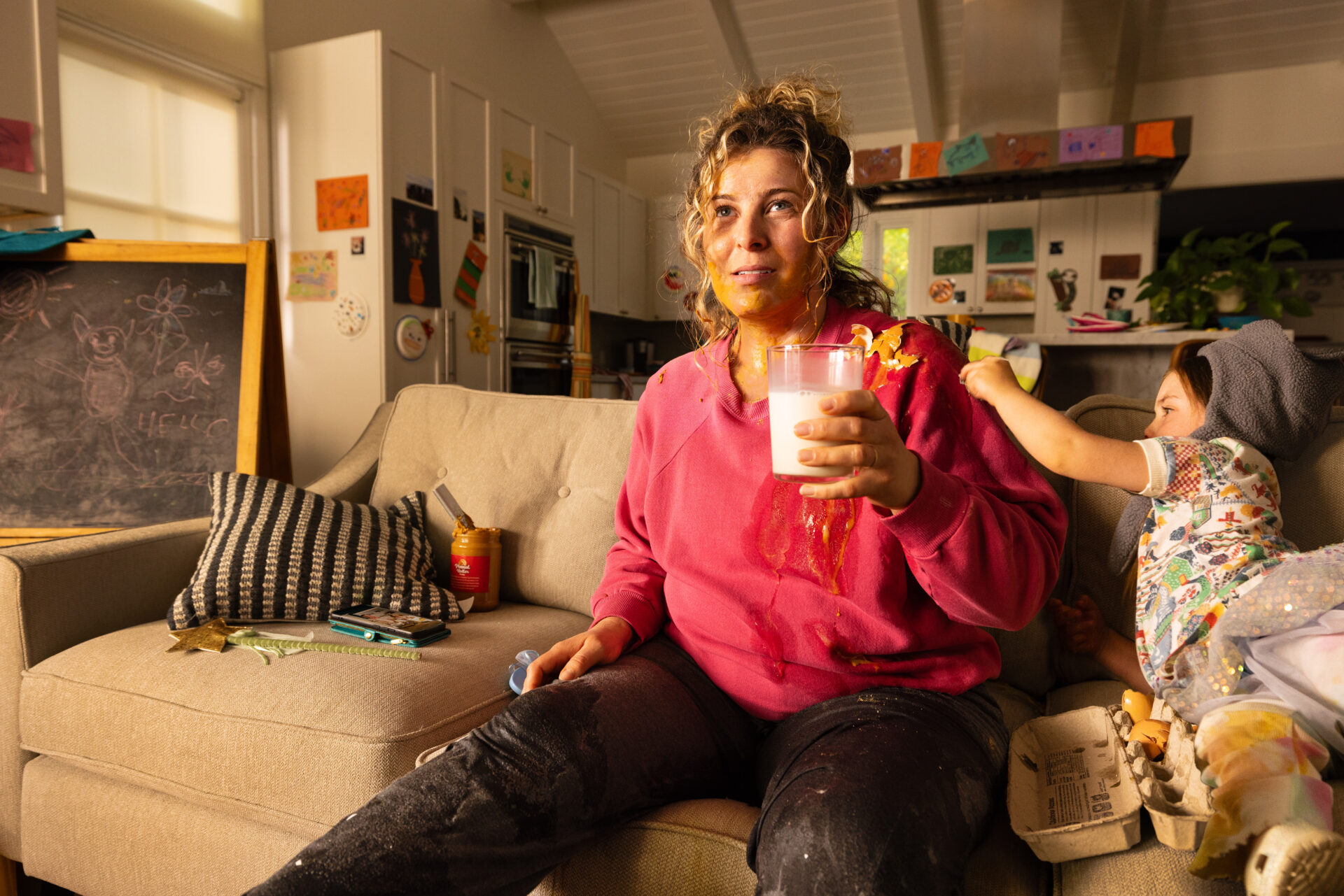 Mom enjoys milk despite the mess her kids have caused.