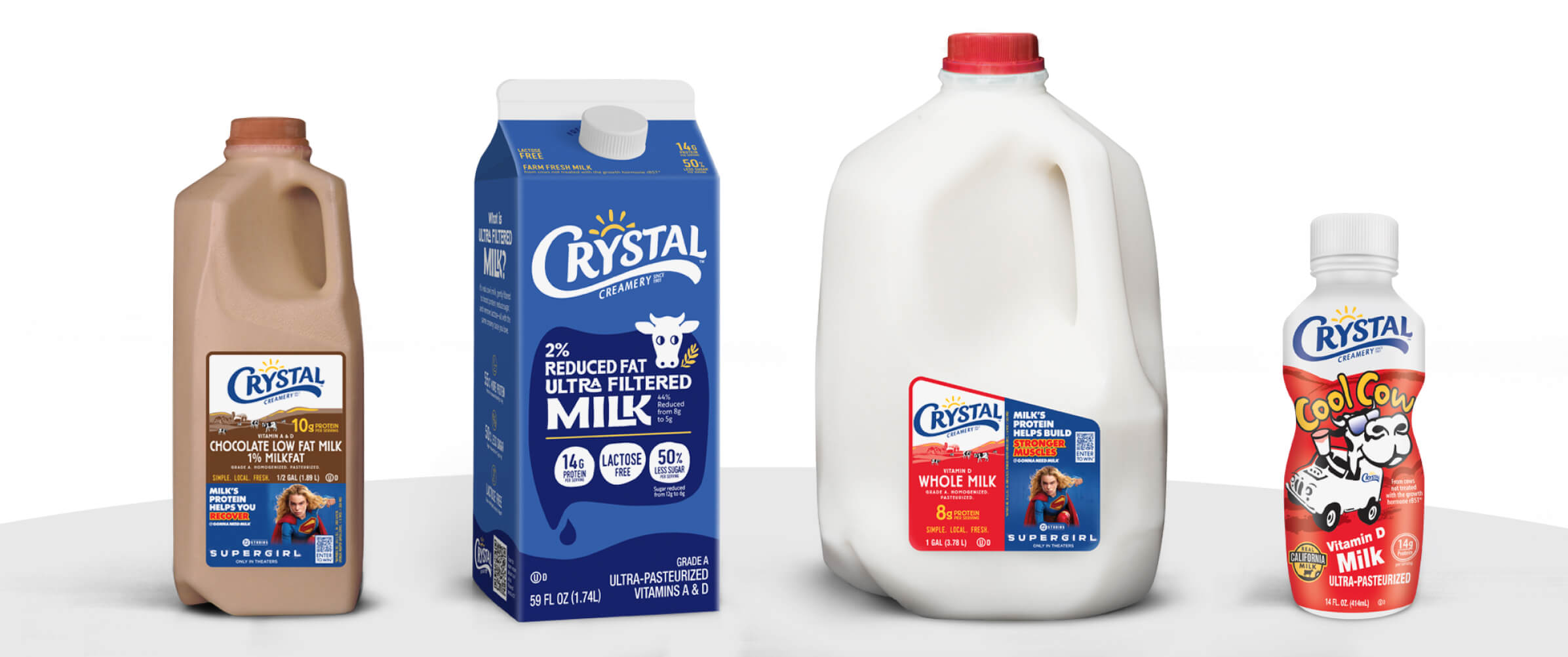 A product lineup of Crystal Creamery Chocolate milk and whole milk in varying gallon sizes.